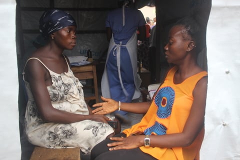 Martha receives psychosocial counselling from Aisha Conteh, CHO at the temporary health post. ©UNFPA Sierra Leone /2017/Angelique Reid